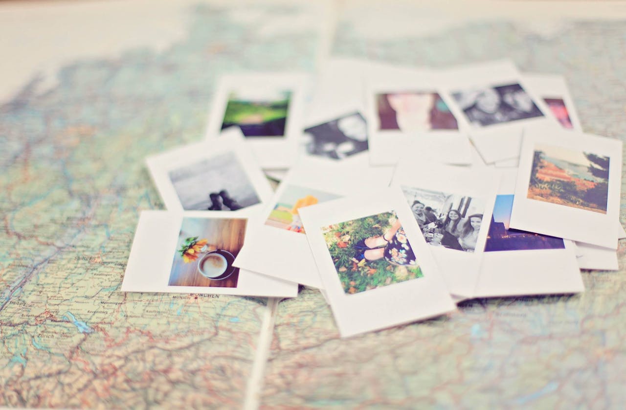 services-02 A collection of Polaroid memories spread across a map, symbolizing travel adventures.